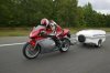 sporty-pull-behind-motorcycle-trailer-going-fast-300x199.jpg